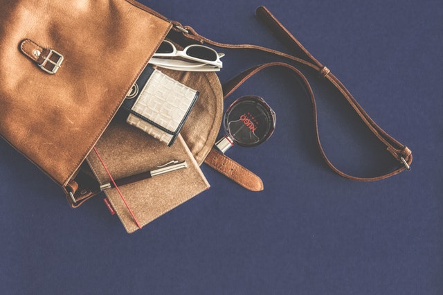 Brown leather bag with contents spilling; photo by lum3n.com on Pexels